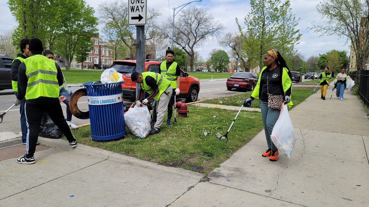 Volunteers in safety vests clearing a Lawndale street